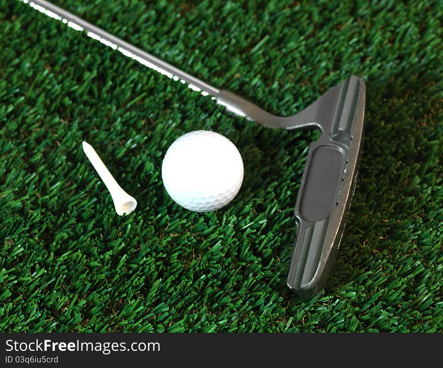 Golfing equipment on artficial grass outdoors