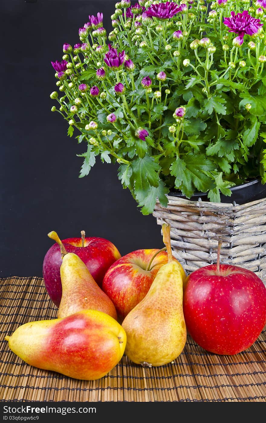 Basket with flowers and fresh fruits. Basket with flowers and fresh fruits