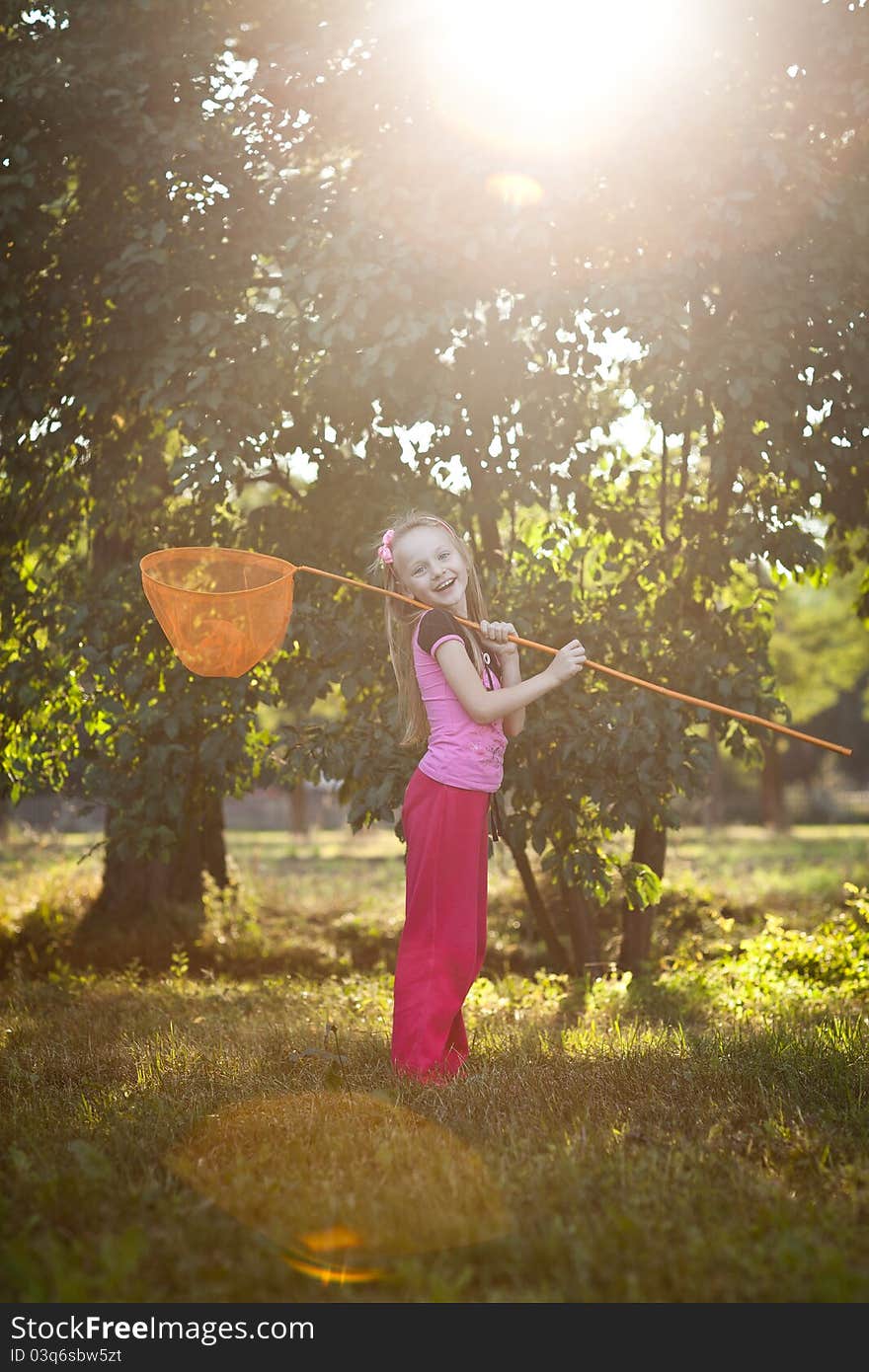 Little girl with butterfly net, in warm sun light. Little girl with butterfly net, in warm sun light