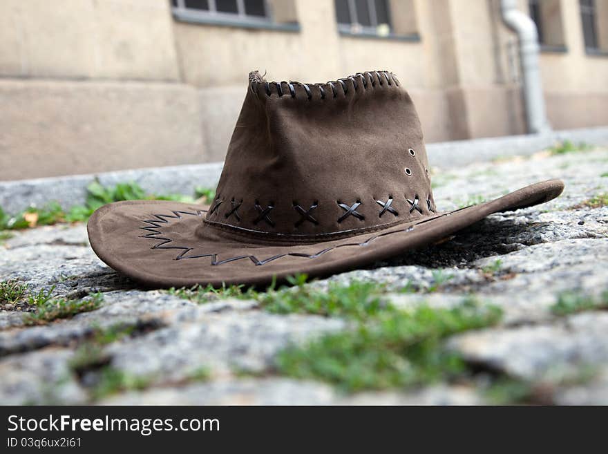 A leather hat on the cobbles street. A leather hat on the cobbles street