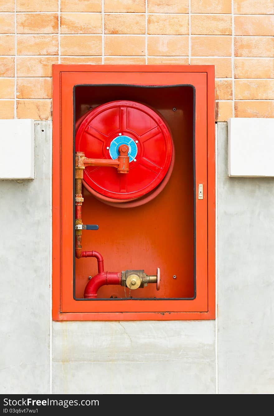 Hydrant with water hoses and fire extinguish equipment on wall. Hydrant with water hoses and fire extinguish equipment on wall