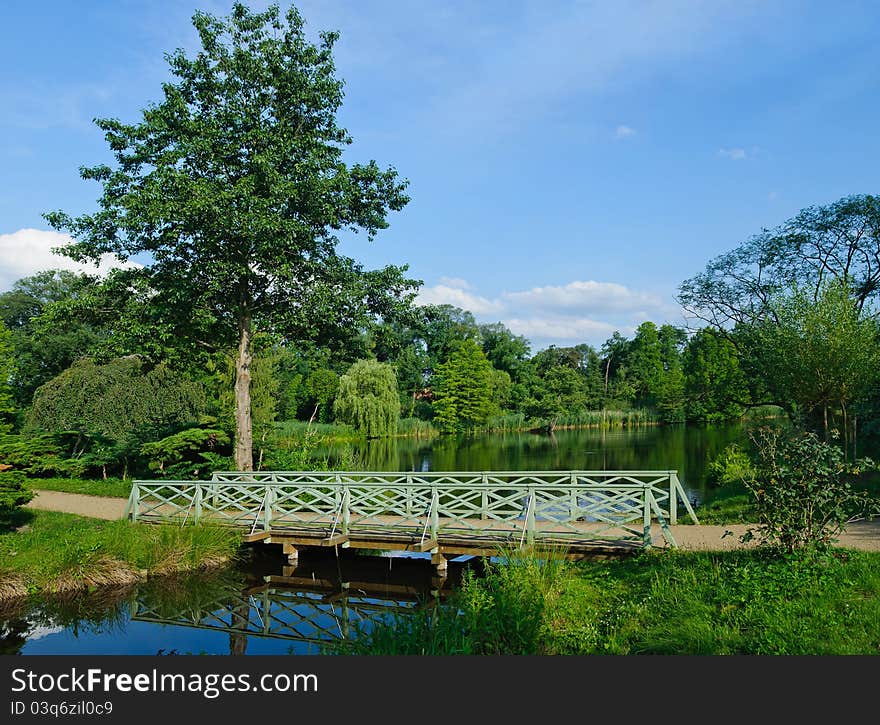 Romantic green wooden footbridge in the Park Sanssouci. Berlin, Germany