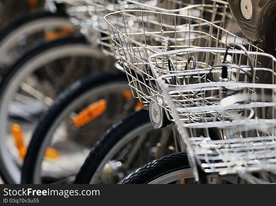 Bicycles with metallic baskets on the city street. Photo with tilt-shift lens. Bicycles with metallic baskets on the city street. Photo with tilt-shift lens