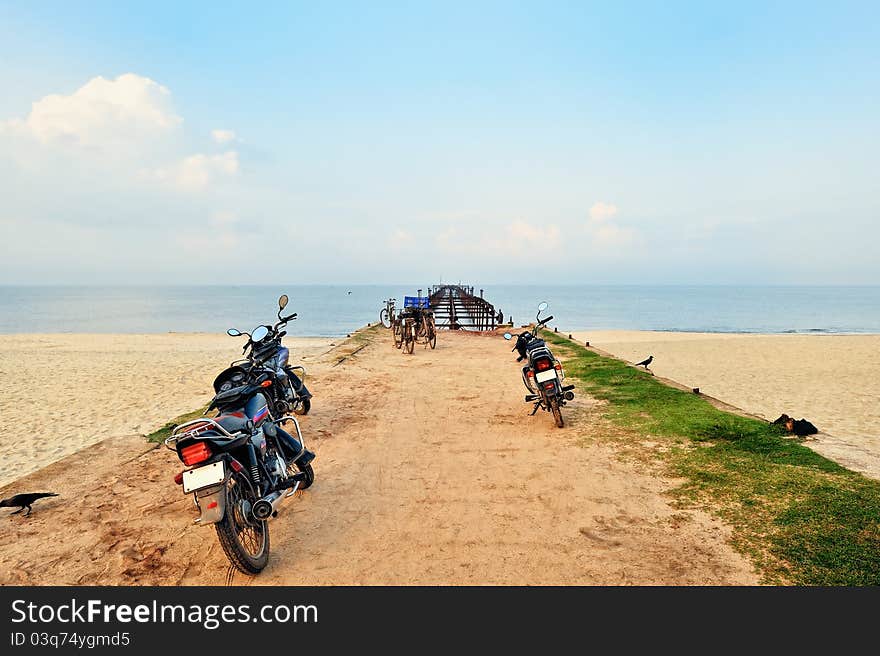 Motorbikes and bicycles on the old ocean pier