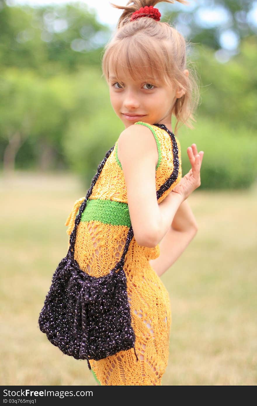 Portrait of the funny little girl in the crocheted dress. Portrait of the funny little girl in the crocheted dress