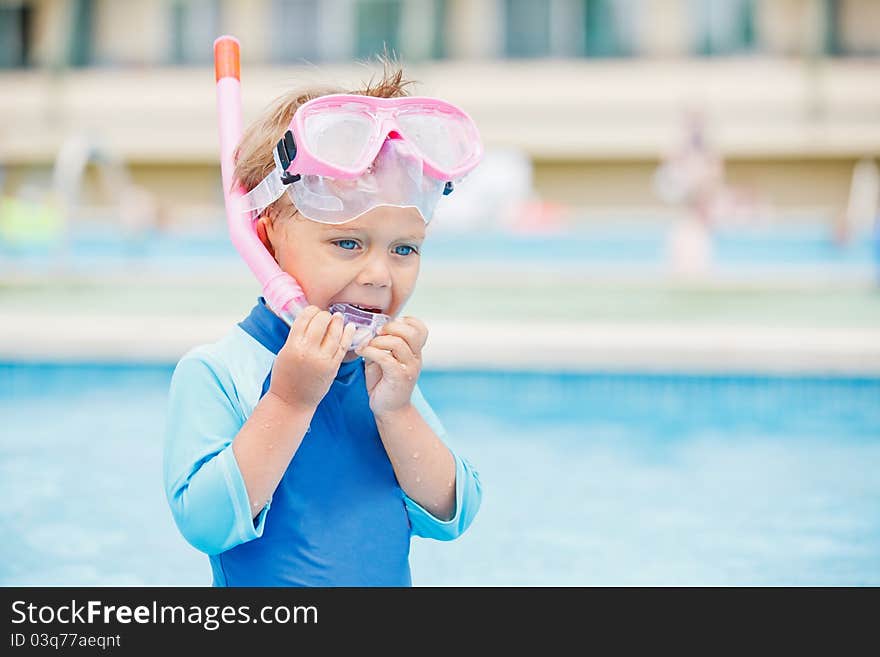 Boy playing in a pool of water during the summer