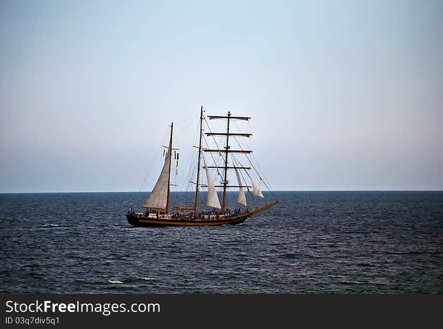 Old sailing ship in the sea .