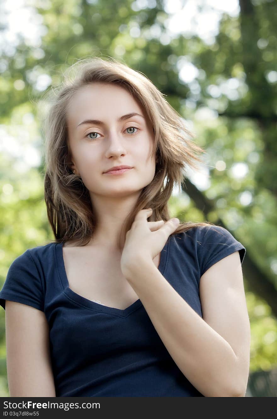 Portrait of a young woman on blured forest background