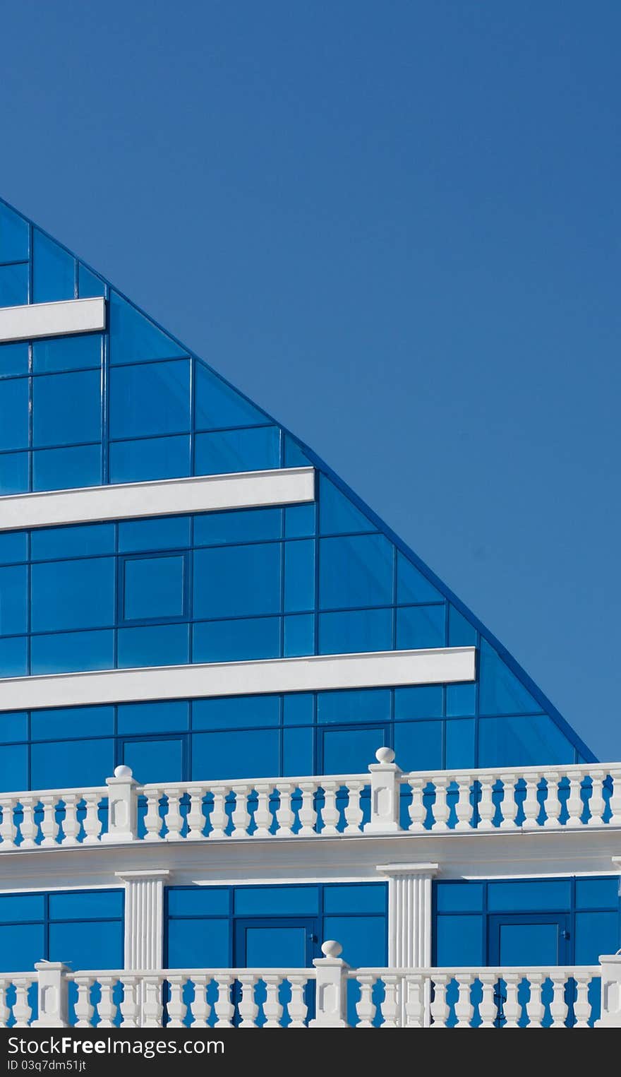 Part of modern building over blue sky