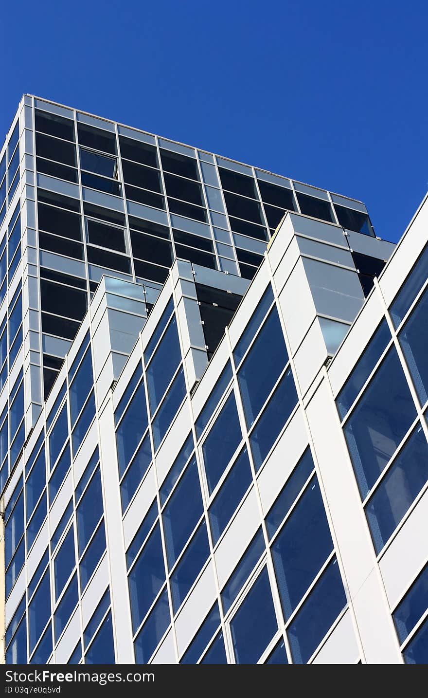 Part of modern building over blue sky