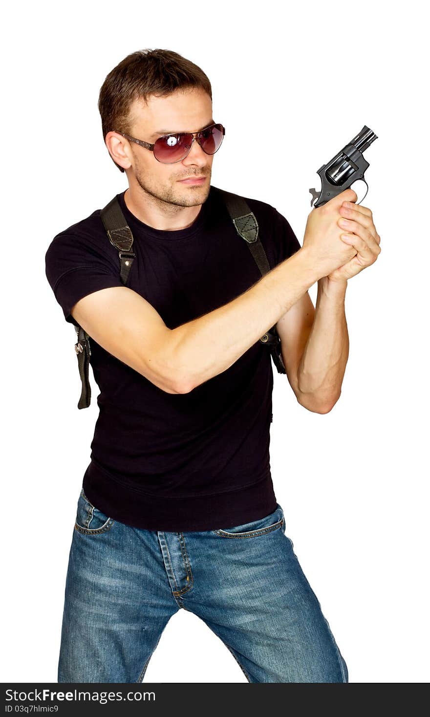 White male dressed in black on an isolated background wearing a shoulder holster armed with an revolver. White male dressed in black on an isolated background wearing a shoulder holster armed with an revolver