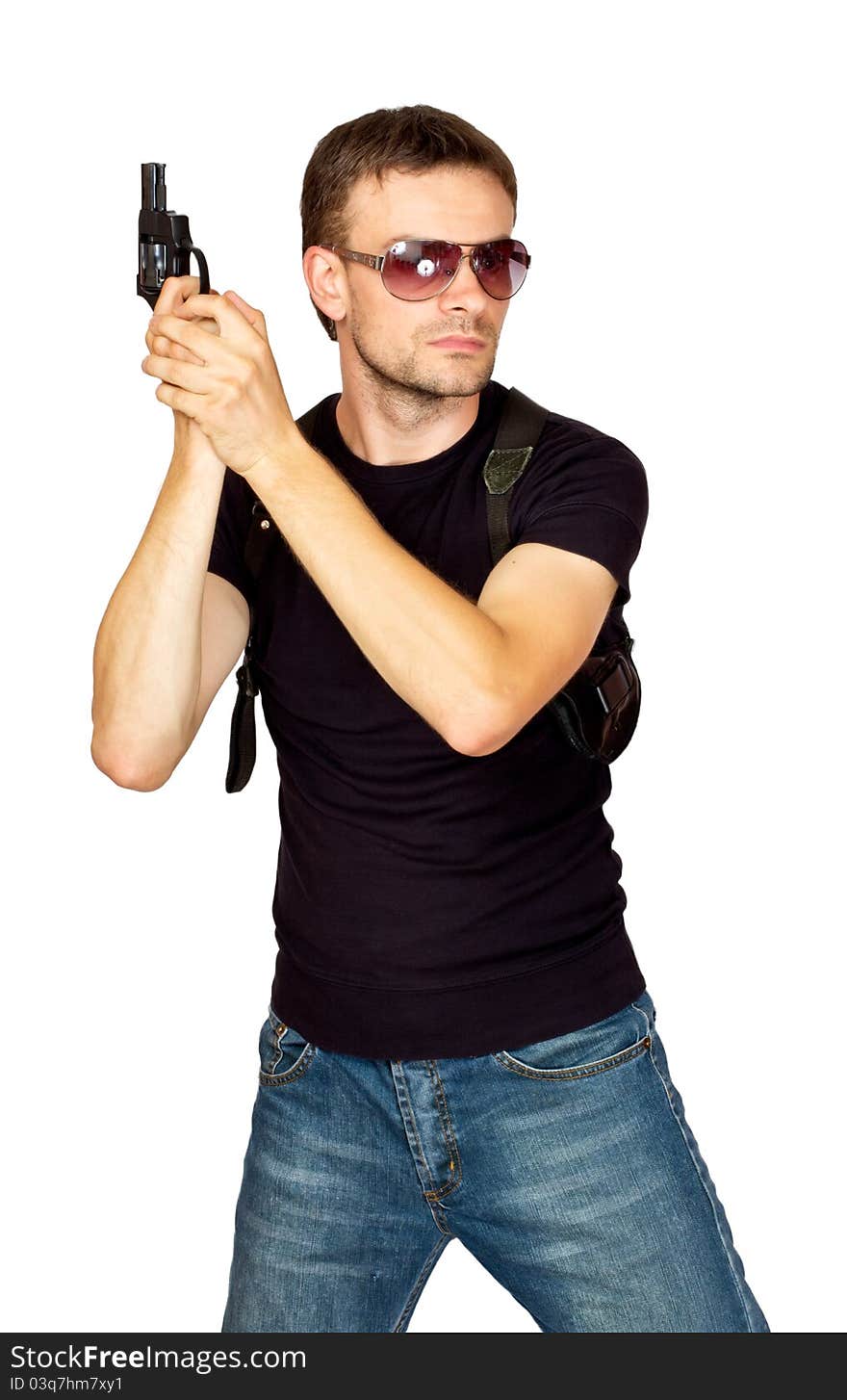 White male dressed in black on an isolated background wearing a shoulder holster armed with an revolver. White male dressed in black on an isolated background wearing a shoulder holster armed with an revolver