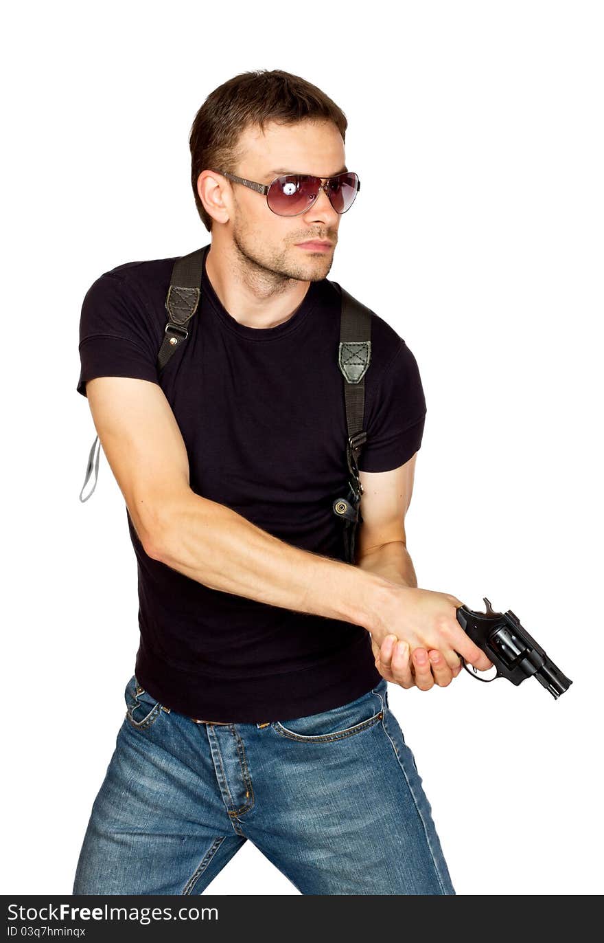 White male dressed in black on an isolated background wearing a shoulder holster armed with an revolver. White male dressed in black on an isolated background wearing a shoulder holster armed with an revolver