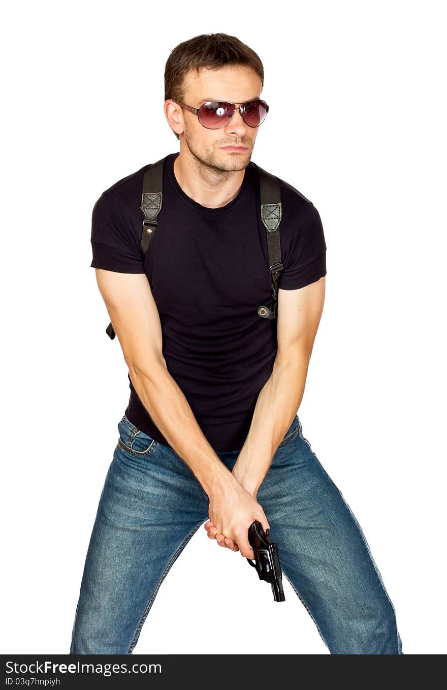 White male dressed in black on an isolated background wearing a shoulder holster armed with an revolver. White male dressed in black on an isolated background wearing a shoulder holster armed with an revolver