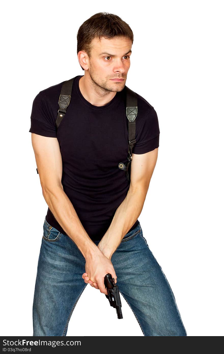 White male dressed in black on an isolated background wearing a shoulder holster armed with an revolver. White male dressed in black on an isolated background wearing a shoulder holster armed with an revolver