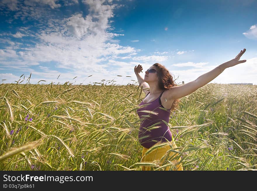 Pregnant Woman On Green Grass Field Under Blue Sky