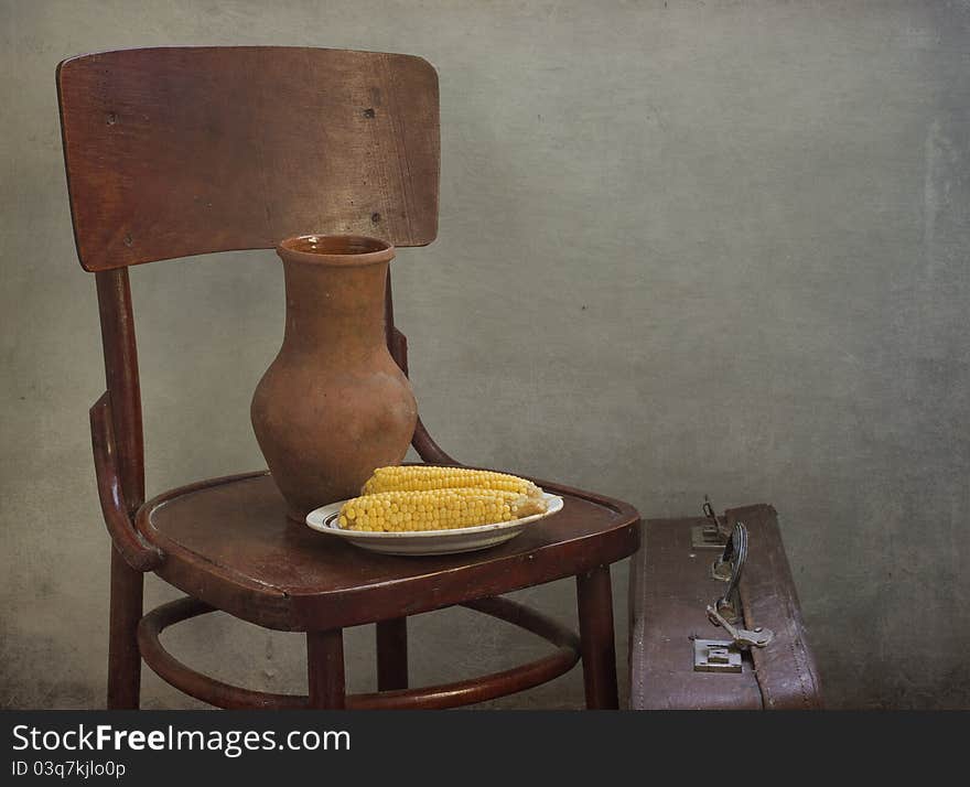 Jug and corn on a chair