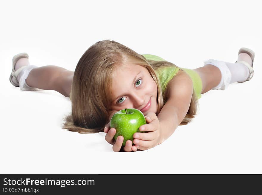 Little blond girl with green eyes holding a green apple. Little blond girl with green eyes holding a green apple