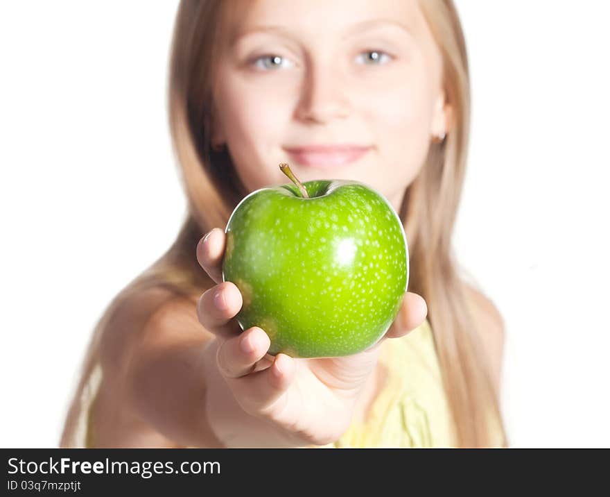 Little girl holding out a green apple isolated on white. Little girl holding out a green apple isolated on white