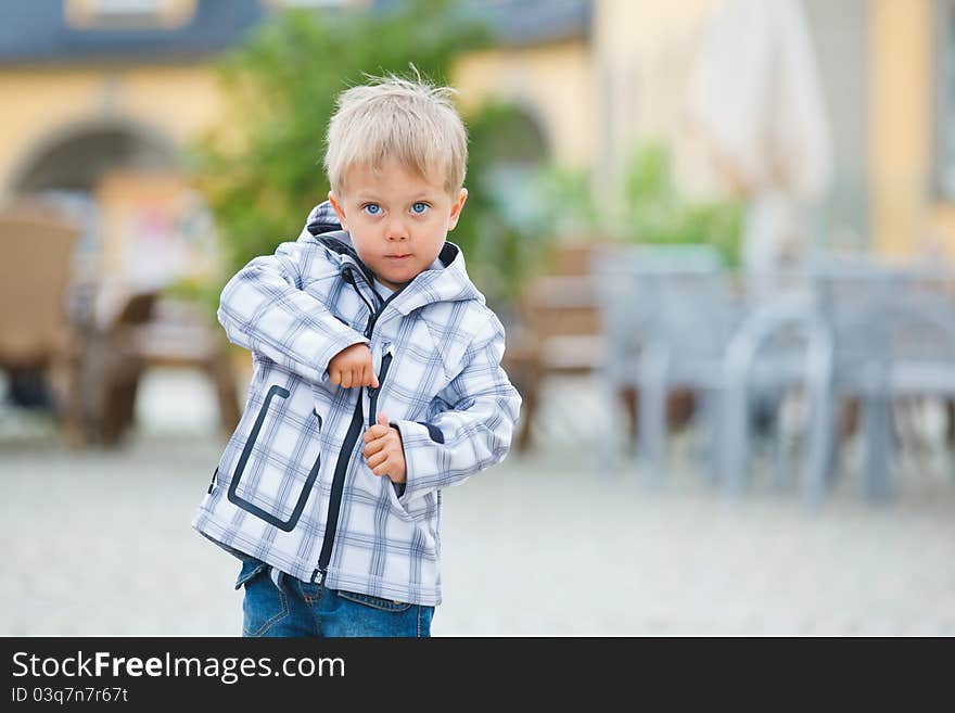 Cute little boy outdoors in city street. Cute little boy outdoors in city street