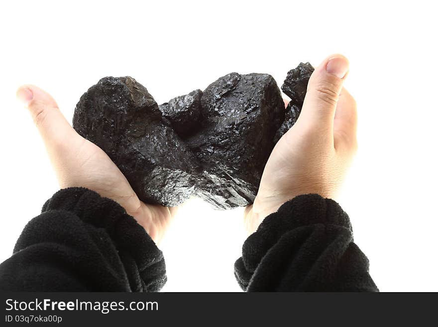 Pieces of coal in hand isolated on white background