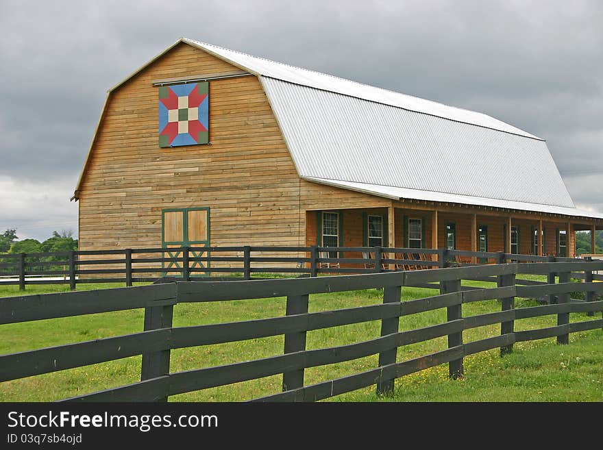 A barn with a quilt square over the door. A barn with a quilt square over the door