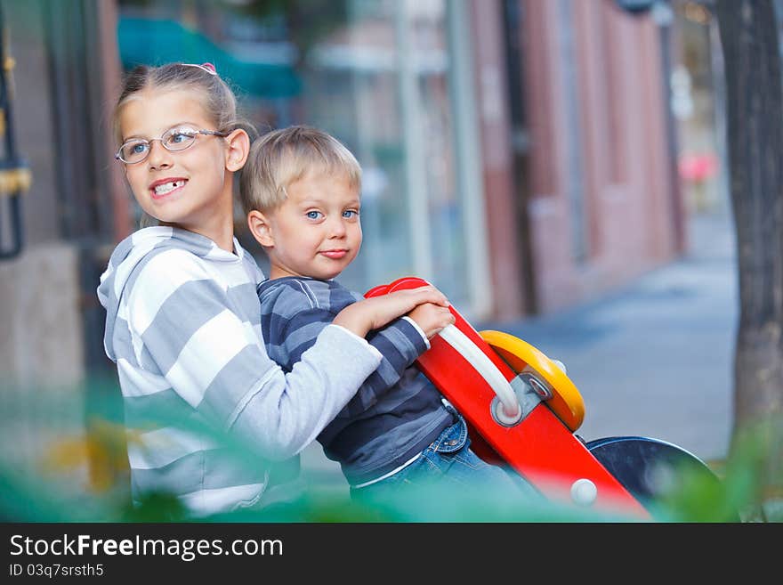 Happy Kids Ride On The Swings At The Playground