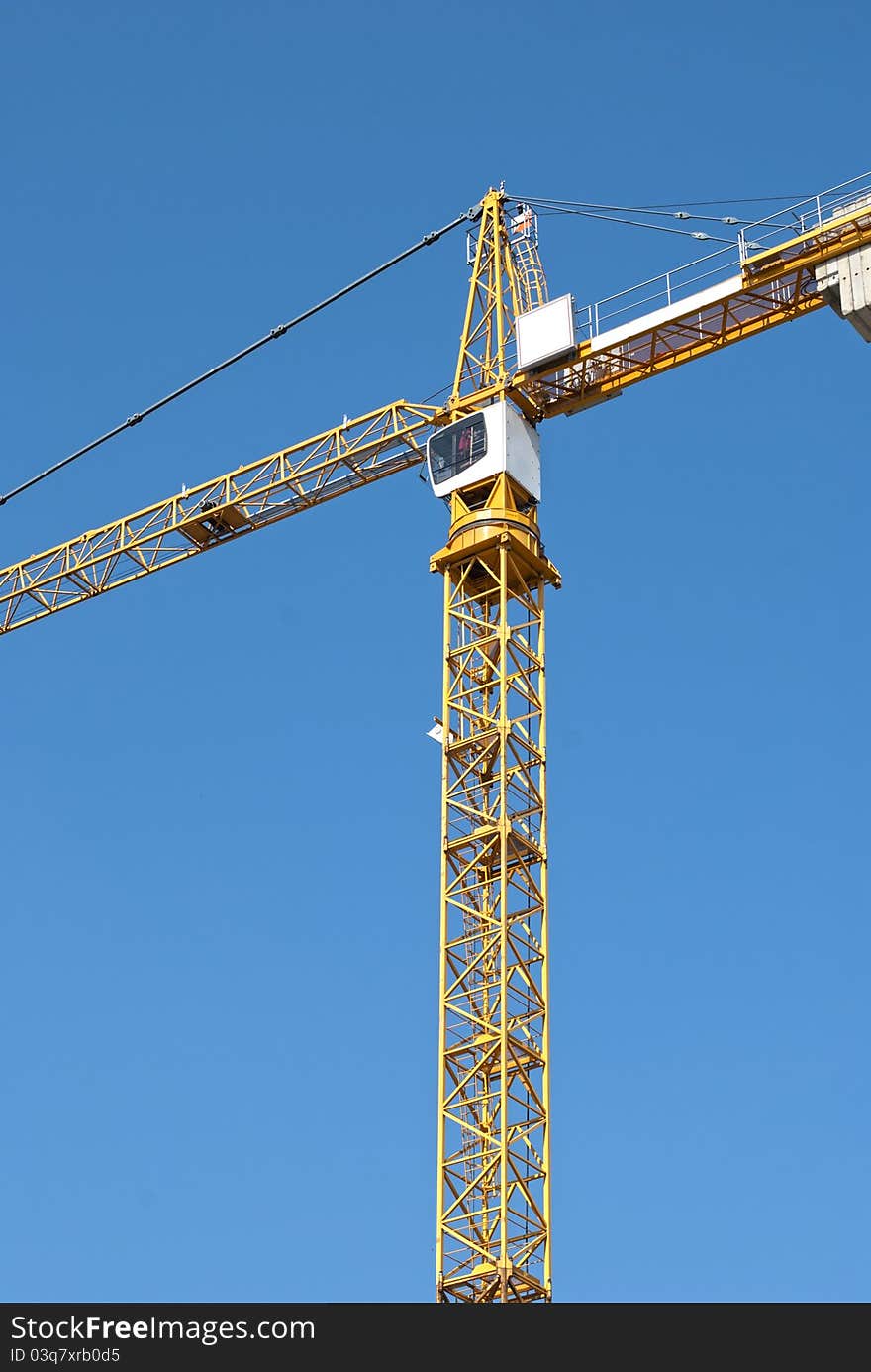 Yellow crane on blue sky background