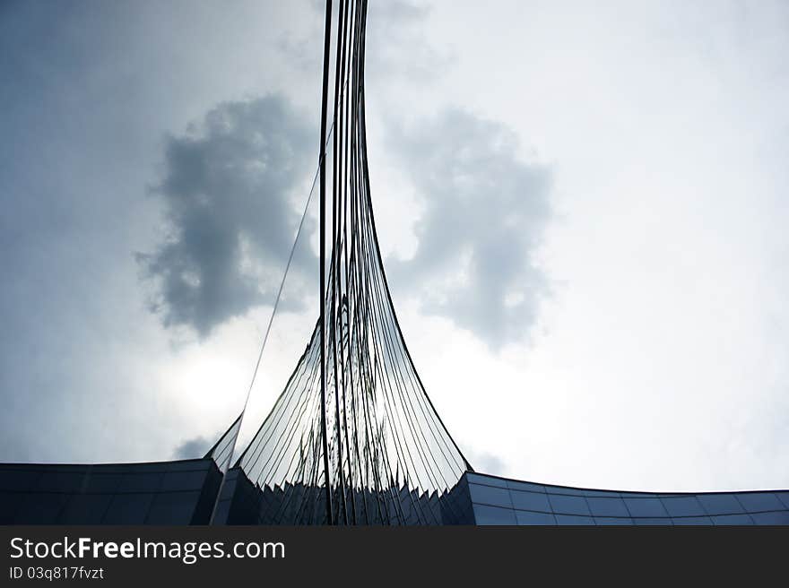 Curve arc glass structure reflecting the clear blue sky