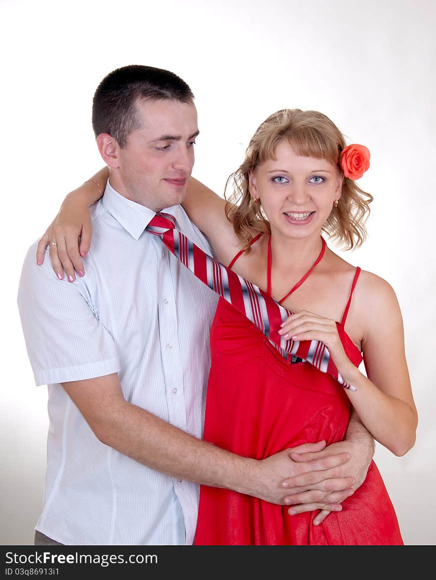 Wife pulling her nusbands necktie isolated. Wife pulling her nusbands necktie isolated