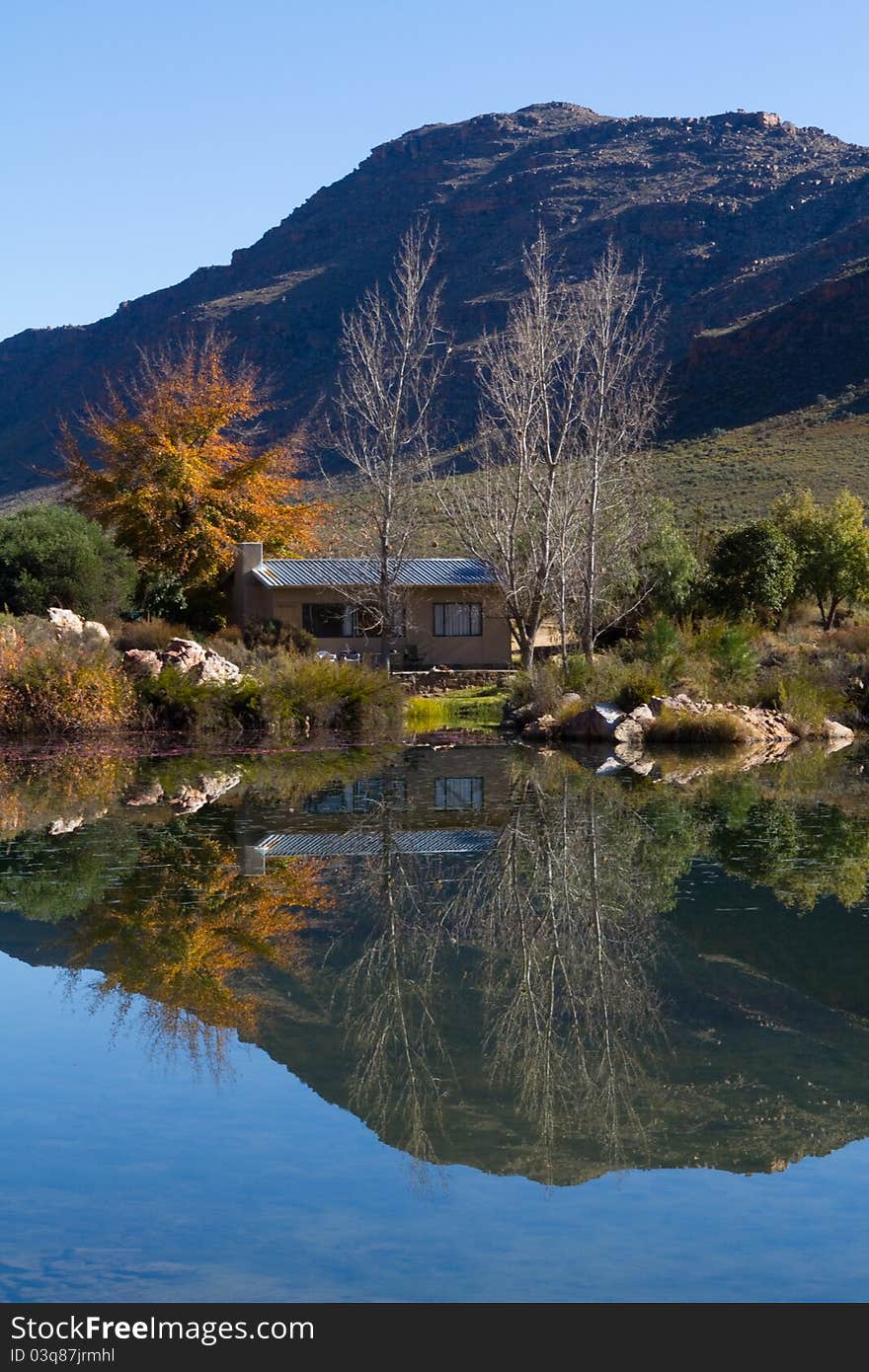 A small holiday home next to a lake with stunning reflextion in the water. A small holiday home next to a lake with stunning reflextion in the water