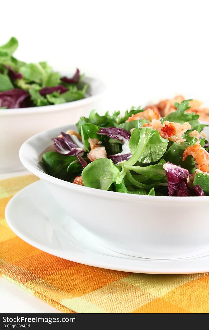 Mixed, colorful salad with crayfish on a white background. Mixed, colorful salad with crayfish on a white background