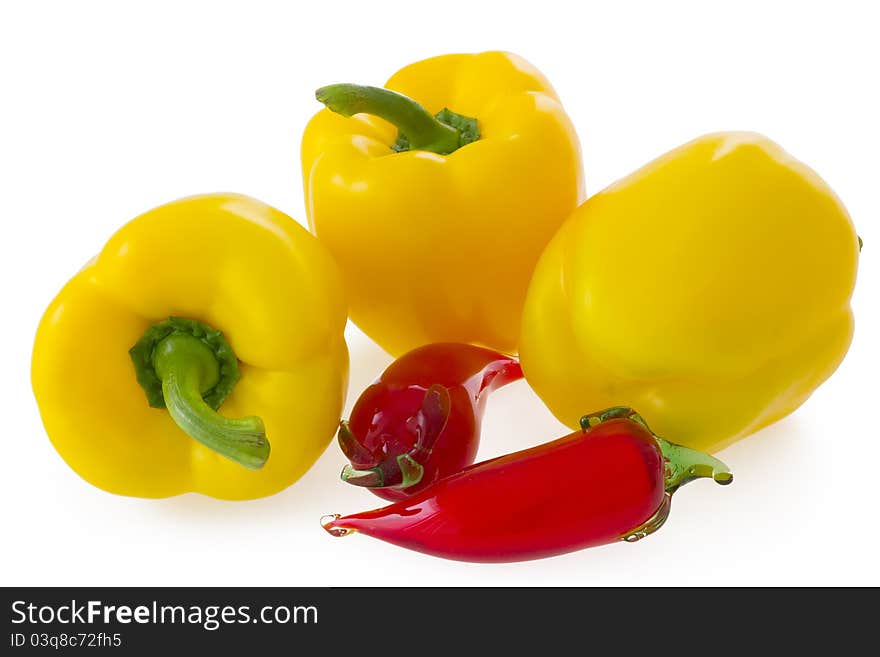 Yellow bell pepper and glass ornament chilli pepper, on white background. Yellow bell pepper and glass ornament chilli pepper, on white background