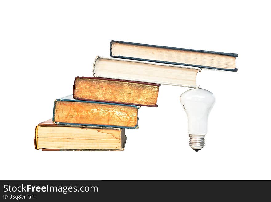 A lamp under the ancient books isolated on whith background