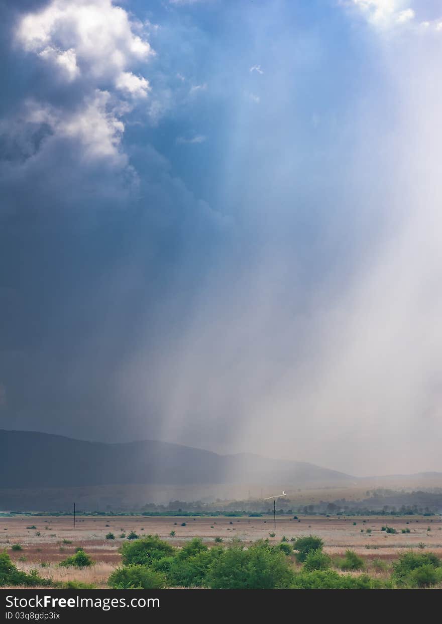 Heavy rain and storm on horizon with dramatic sky clouds. Heavy rain and storm on horizon with dramatic sky clouds