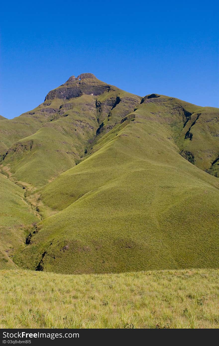 A peak in south africa's drakensberg mountains photographed on a sunny day with blue skies. A peak in south africa's drakensberg mountains photographed on a sunny day with blue skies