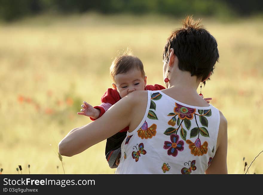 Mother and daughter in a poppy field