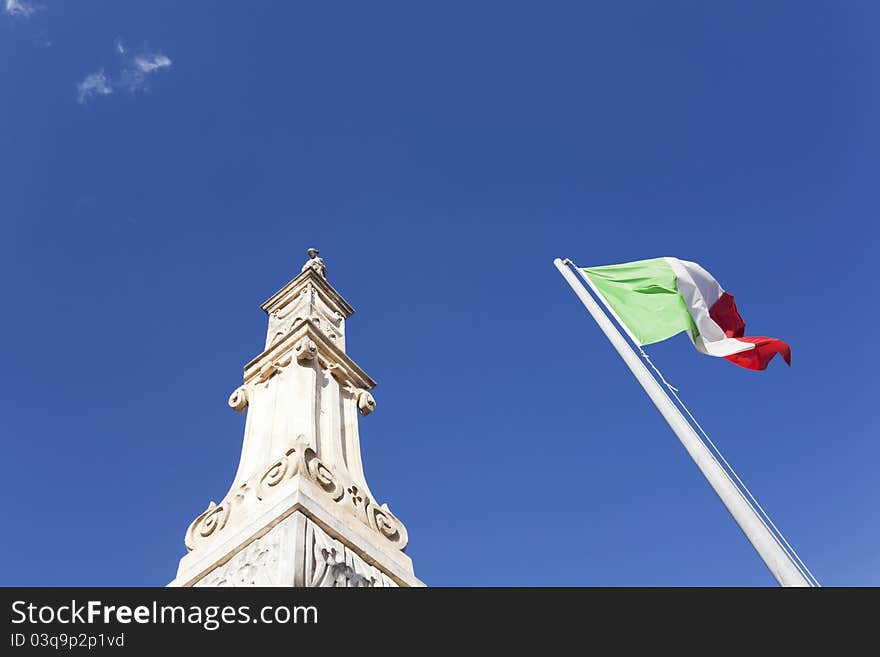 Waving italian flag against blue sky