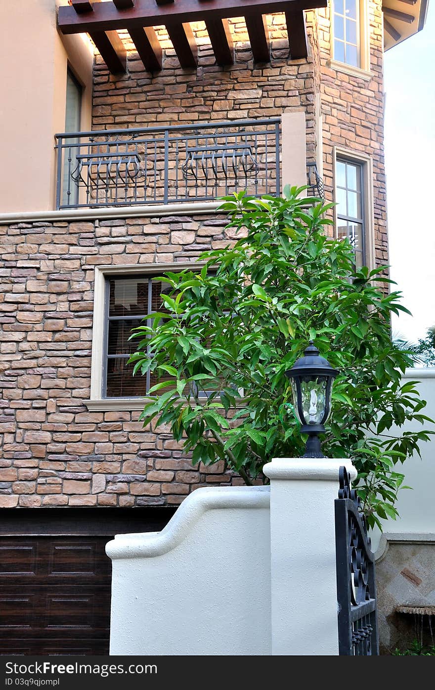 A small villa building detail, including wall and window, under lighting of sunset, shown as architecture geometric detail and color and texture under sunset lighting. A small villa building detail, including wall and window, under lighting of sunset, shown as architecture geometric detail and color and texture under sunset lighting.