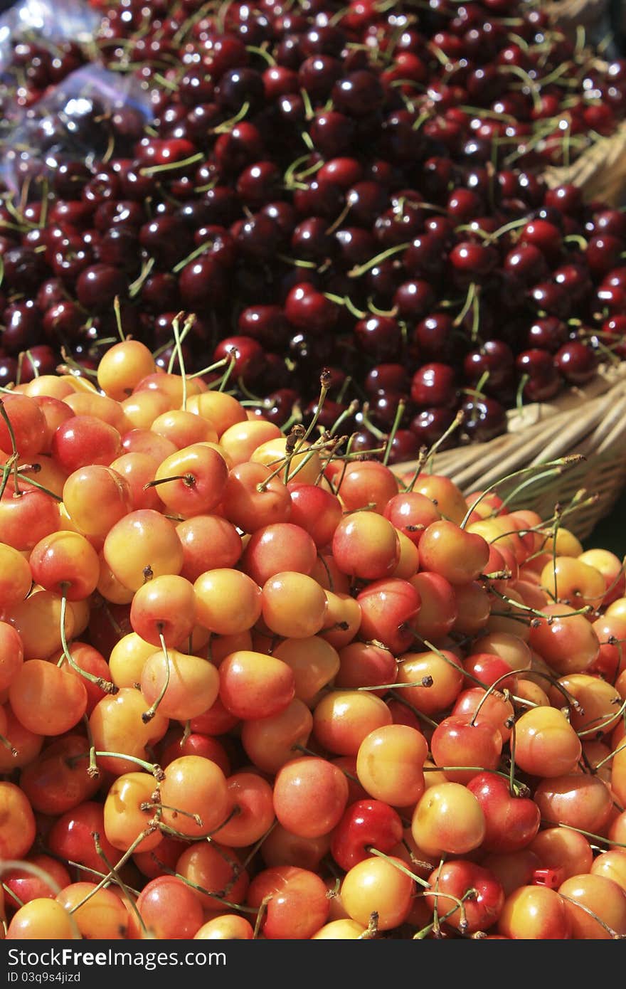 Red and yellow cherries for sale at a farmer's market