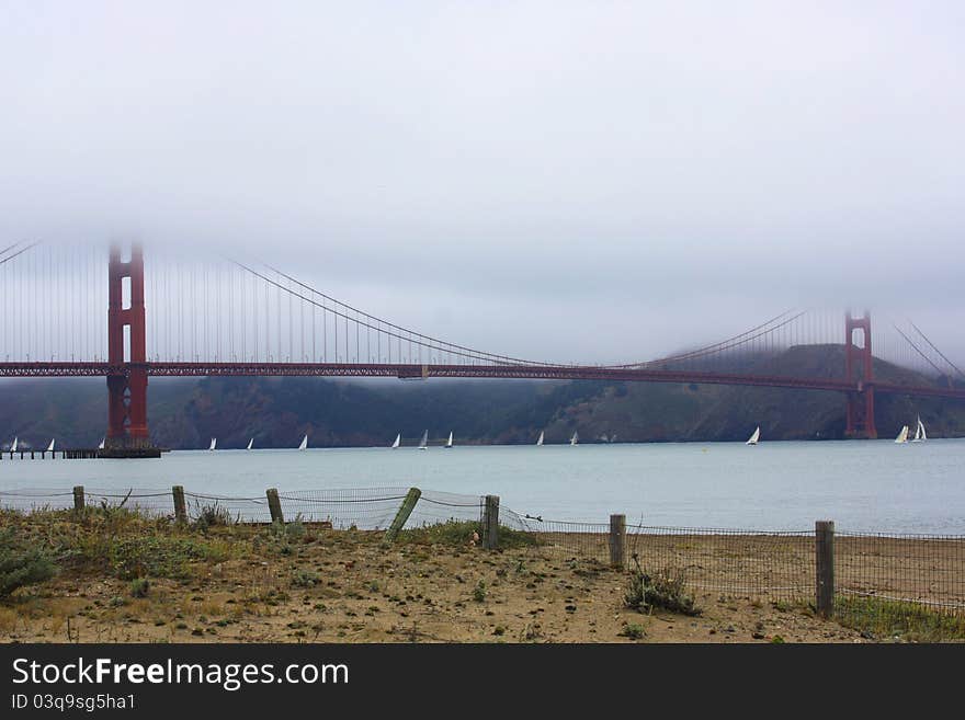 View of sailboats and the golden gate bridge on a foggy morning. View of sailboats and the golden gate bridge on a foggy morning