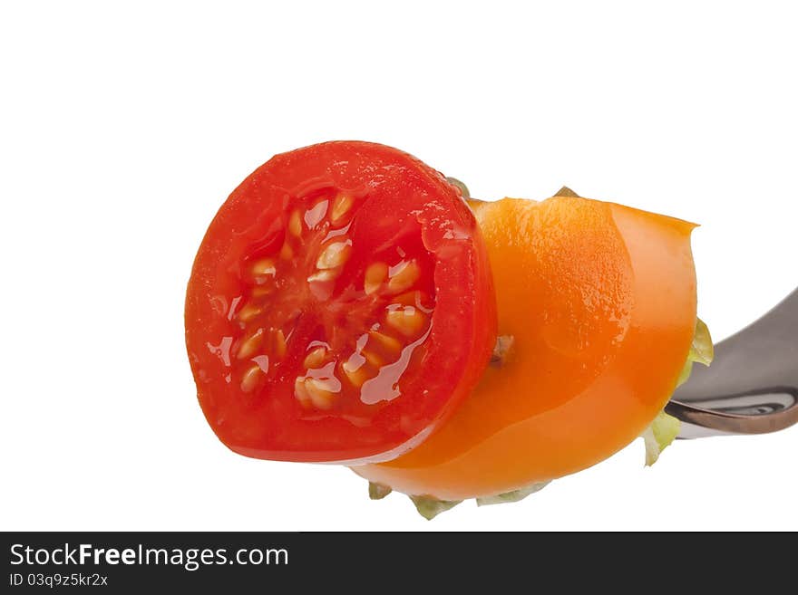 Sandwich of tomato, peppers and lettuce on a fork. Sandwich of tomato, peppers and lettuce on a fork.