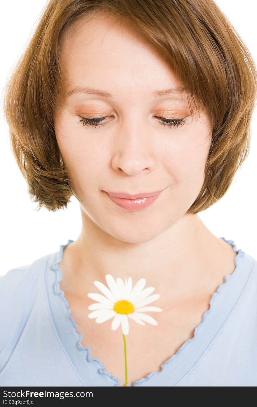 Girl smelling a flower on a white background. Girl smelling a flower on a white background.