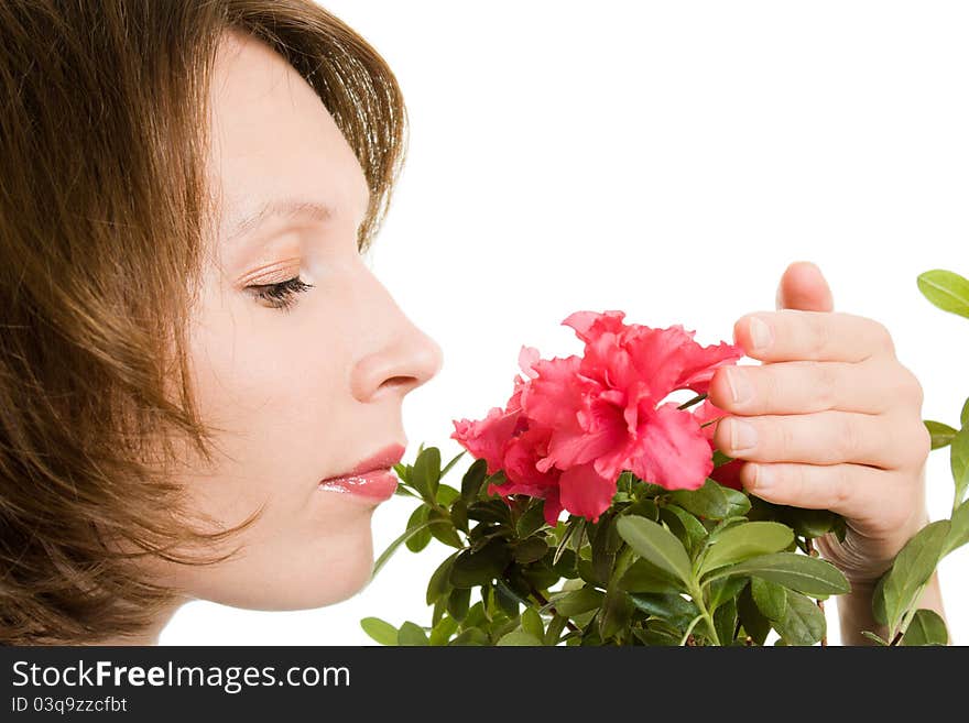 Girl smelling a flower on a white background. Girl smelling a flower on a white background.