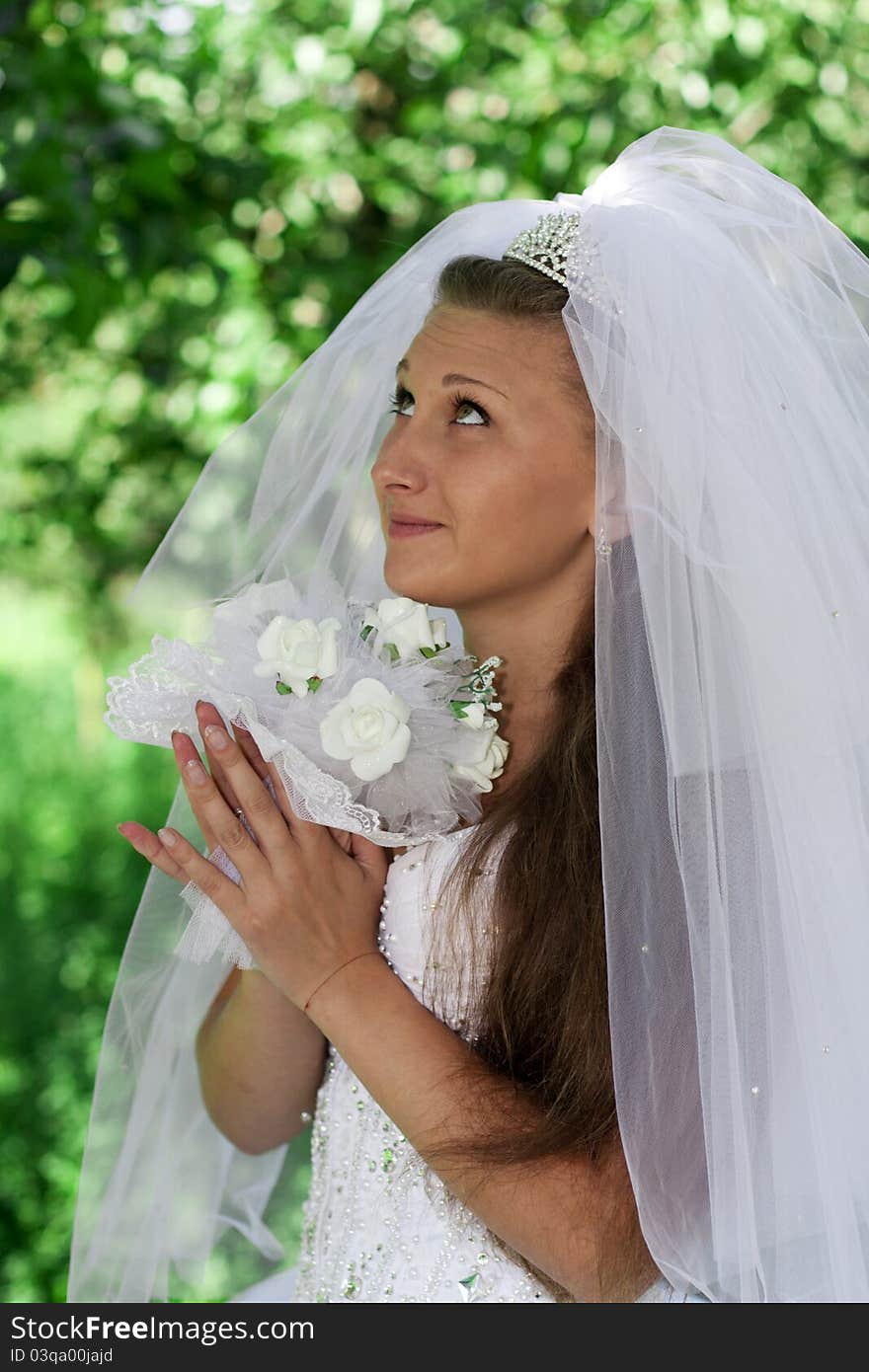 The bride with a bouquet on a green background. The bride with a bouquet on a green background