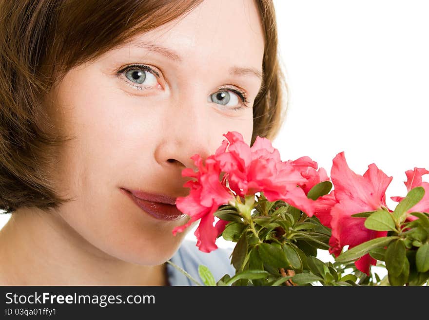 Girl smelling a flower on a white background. Girl smelling a flower on a white background.