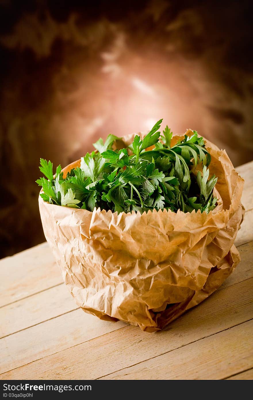 Photo of fresh parsley inside a paper bag on wooden table