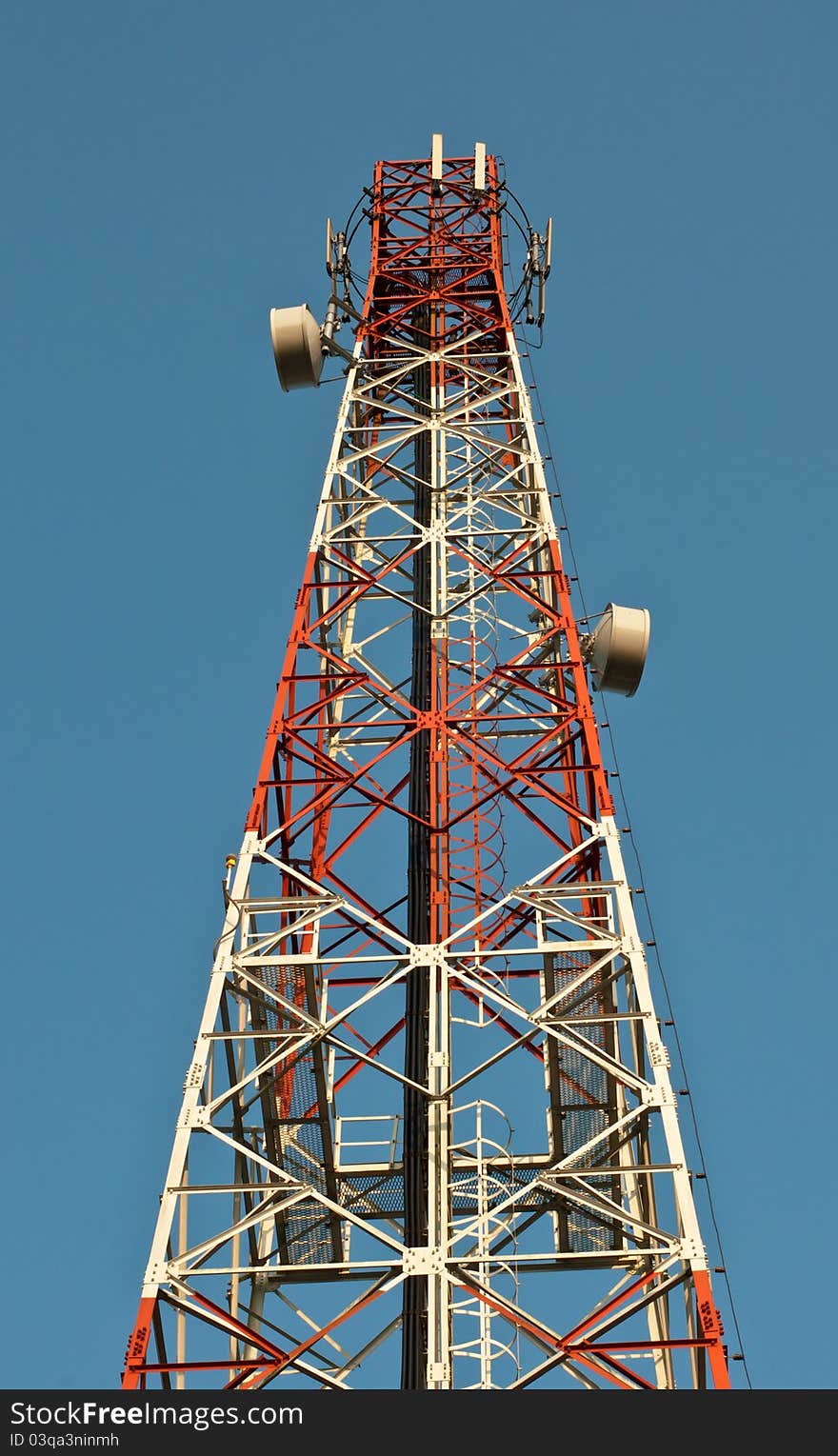 Telecommunication tower over a blue sky.