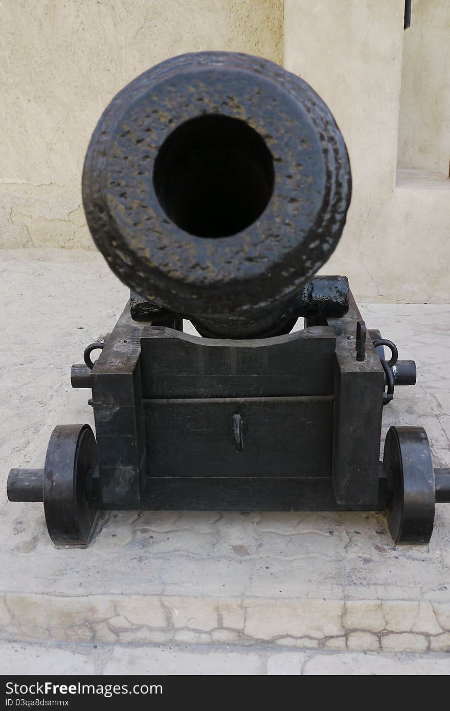 Frontal view of an ancient restored iron cannon in the Dubai fort. Frontal view of an ancient restored iron cannon in the Dubai fort