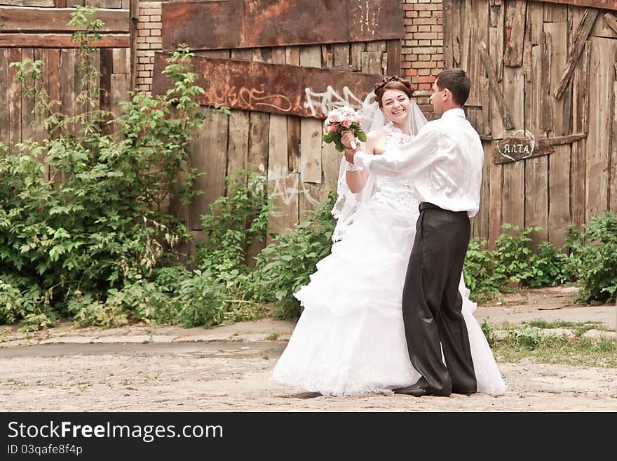 Bride and groom dancing outdoor